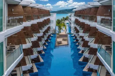 a view from the balcony of a hotel with a pool at The Beachfront Hotel Phuket in Rawai Beach