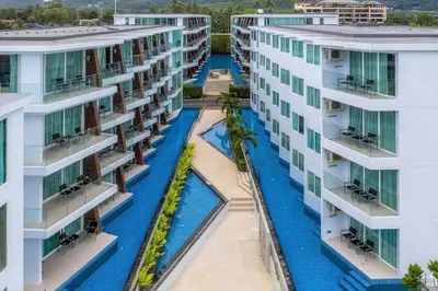 an aerial view of a building with a swimming pool at The Beachfront Hotel Phuket in Rawai Beach