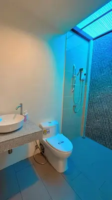 a bathroom with a shower and a toilet and a sink at Bests Village & Villa - Chalong Bay Phuket in Chalong
