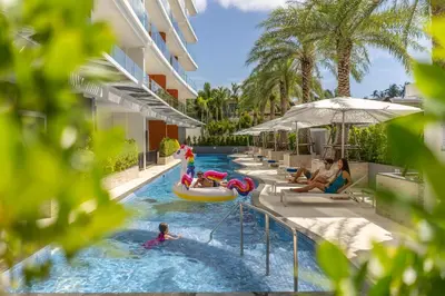 a pool at the resort with people in it at Babylon Sky Garden in Rawai Beach