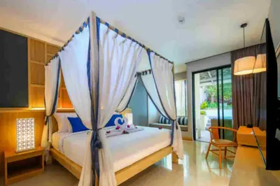 a bedroom with a bed with a canopy at CRAFT Resort & Villas, Phuket Town - scheduled shuttle to Phuket Old Town in Phuket Town