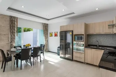 a kitchen and dining room with a table and chairs at Trixie Town House 2 With Private Pool in Rawai Beach