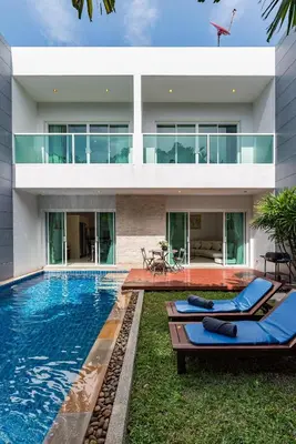 a house with a swimming pool in front of it at Trixie Town House 2 With Private Pool in Rawai Beach