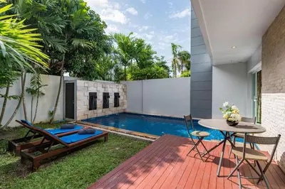 a backyard with a pool and a table and chairs at Trixie Town House 2 With Private Pool in Rawai Beach