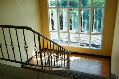 a spiral staircase in a house with windows at Raya Rawai Place in Rawai Beach