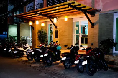 a group of motorcycles parked in front of a building at Raya Rawai Place in Rawai Beach