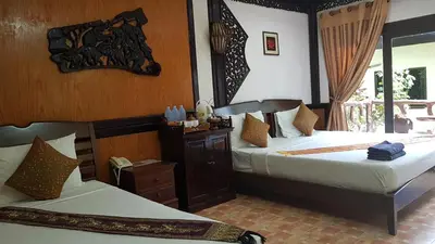 a bedroom with two beds and a window at Paradise Pearl Bungalows in Phi Phi Don