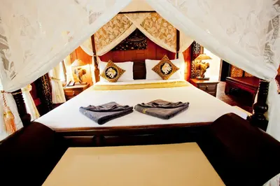 a bedroom with a bed with two towels on it at Paradise Pearl Bungalows in Phi Phi Don