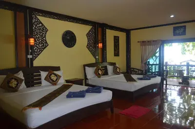 a bedroom with two beds and a window at Paradise Pearl Bungalows in Phi Phi Don