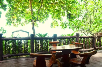a wooden table and chairs on a wooden deck at Paradise Pearl Bungalows in Phi Phi Don