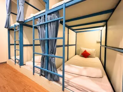 a bunk bed room with two bunk beds at Sleepy Station Hostel in Kata Beach