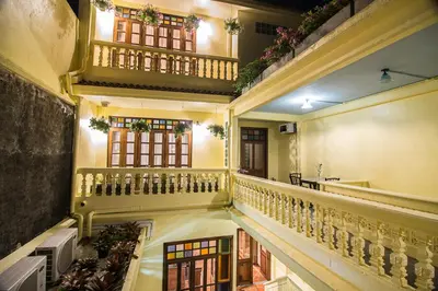 an empty hallway with stairs and windows in a building at WOO Gallery & Boutique hotel in Phuket Town