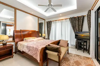 a bedroom with a bed and a piano at Champagne Villa Luxurious Tropical Pool Villa in Rawai Beach