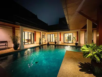 a large swimming pool in a house at Champagne Villa Luxurious Tropical Pool Villa in Rawai Beach