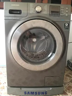 a silver washing machine with its door open at Beautiful 3 Bedroom Garden Villa in Chalong