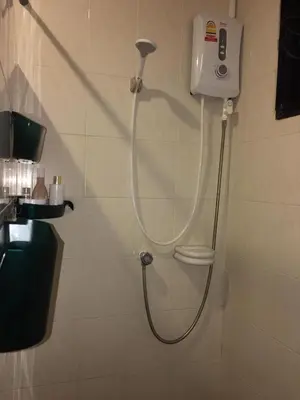a shower in a bathroom with a shower head at Beautiful 3 Bedroom Garden Villa in Chalong