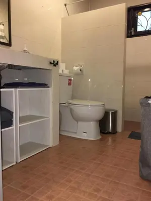 a bathroom with a white toilet in a room at Beautiful 3 Bedroom Garden Villa in Chalong