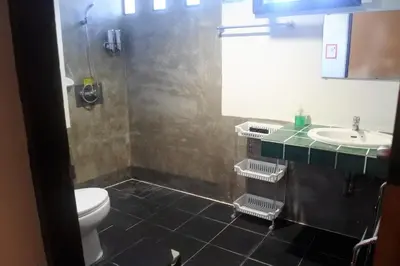 a bathroom with a shower and a toilet and a sink at Hi Karon Beach in Karon Beach