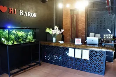 a fish tank sitting next to a counter in a room at Hi Karon Beach in Karon Beach