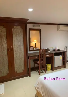 a bedroom with a desk and a bed with a mirror at Le Tanjong House in Patong Beach