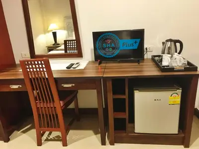 a desk with a computer and a chair in a room at Le Tanjong House in Patong Beach