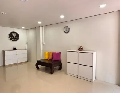 a room with a bench and a clock on a wall at Le Tanjong House in Patong Beach