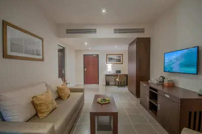a living room with a couch and a table at Thanyapura Sports & Health Resort in Thalang