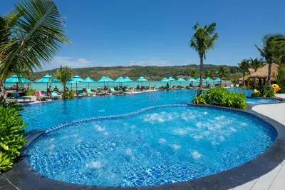 a large pool with chairs and umbrellas at a resort at Phi Phi CoCo Beach Resort in Phi Phi Don