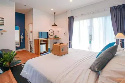 a bedroom with a large bed with a box on it at The Seaton House in Rawai Beach
