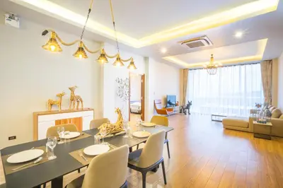 a dining room and living room with a table and chairs at Nakara Hill Phuket in Chalong