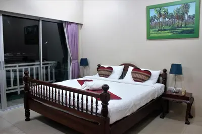 a bedroom with a large bed with white sheets and pillows at Freedom Kata in Kata Beach