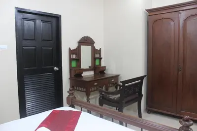a bedroom with a bed and a dresser and a mirror at Freedom Kata in Kata Beach
