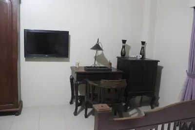 a living room with a desk and a tv on a wall at Freedom Kata in Kata Beach