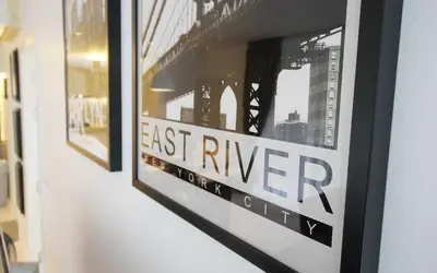 a framed picture of the east river on a wall at Zen Hillside Self Service Apartment in Kamala Beach