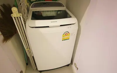 a washing machine sitting in a corner next to a wall at Zen Hillside Self Service Apartment in Kamala Beach