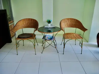 three wicker chairs and a glass table in a room at Orm Thong Hotel - SHA Plus in Kathu