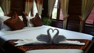 two swans making a heart on a bed at Baannai Lake View Resort in Ao Nang Beach