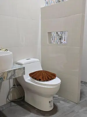 a bathroom with a toilet with a wooden lid at Baannai Lake View Resort in Ao Nang Beach