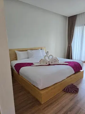 a bedroom with a large bed with a bow on it at Baannai Lake View Resort in Ao Nang Beach
