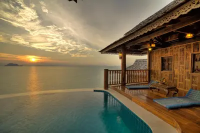 a villa with a swimming pool in front of the ocean at Santhiya Koh Yao Yai Resort & Spa - Compulsory Join Santhiya Speedboat from-to Ao Po Grand Marina at Phuket in Ko Yao Yai
