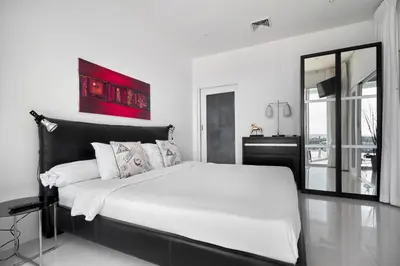 a white bedroom with a large bed and a mirror at Villa Ginborn amazing 5-Bedroom Sea-View Pool Villa 5 Minutes to Kata Beach in Kata Beach
