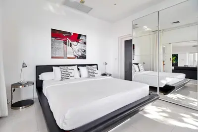 a white bedroom with two beds and a mirror at Villa Ginborn amazing 5-Bedroom Sea-View Pool Villa 5 Minutes to Kata Beach in Kata Beach
