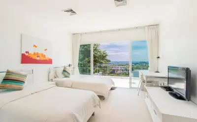 a white bedroom with two beds and a window at Villa Ginborn amazing 5-Bedroom Sea-View Pool Villa 5 Minutes to Kata Beach in Kata Beach