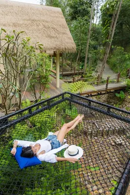 a woman laying in a cage at a zoo at Purana Resort Koh Yao Noi - SHA Extra plus in Ko Yao Noi