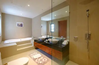 a bathroom with two sinks and a shower at Perfect 2br Pool Villa In Residence Bangtao Beach4 in Bang Tao Beach
