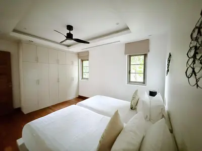 a white bedroom with two beds and a ceiling fan at Perfect 2br Pool Villa In Residence Bangtao Beach4 in Bang Tao Beach