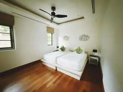 a white bedroom with a bed and a ceiling fan at Perfect 2br Pool Villa In Residence Bangtao Beach4 in Bang Tao Beach