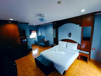 a bedroom with a white bed and blue walls at The Guest House - Apartment in Patong Beach