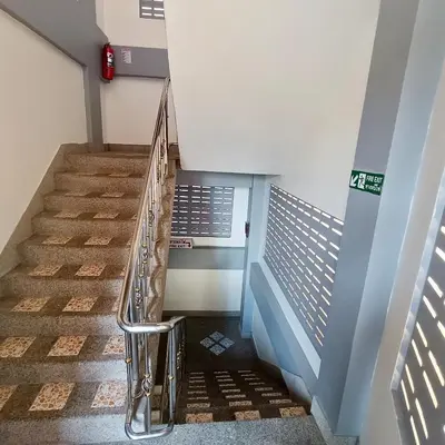 a staircase in a building with blue and white walls at The Guest House - Apartment in Patong Beach