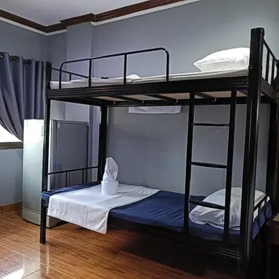 two bunk beds in a room with a bed at The Guest House - Apartment in Patong Beach